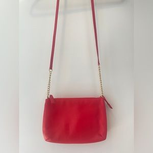 Coral cross body bag with gold chain accents